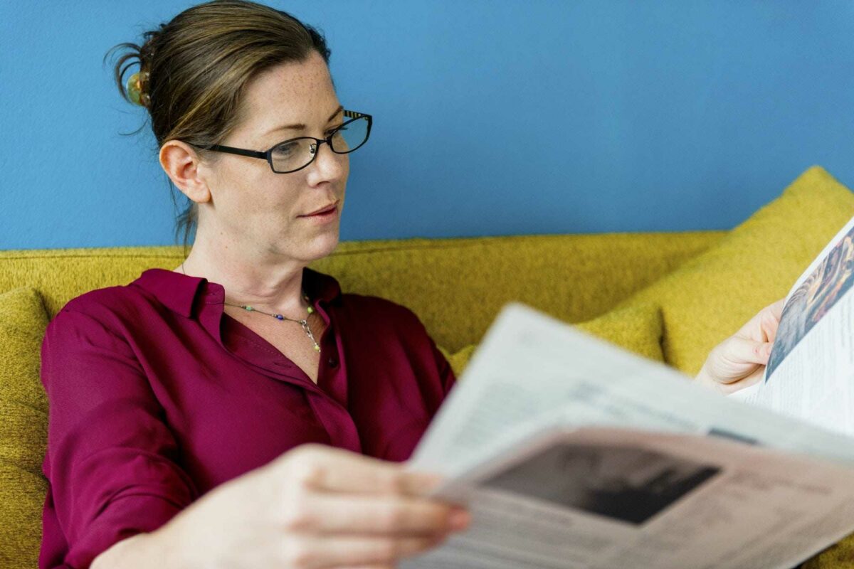 Caucasian woman reading the newspaper
