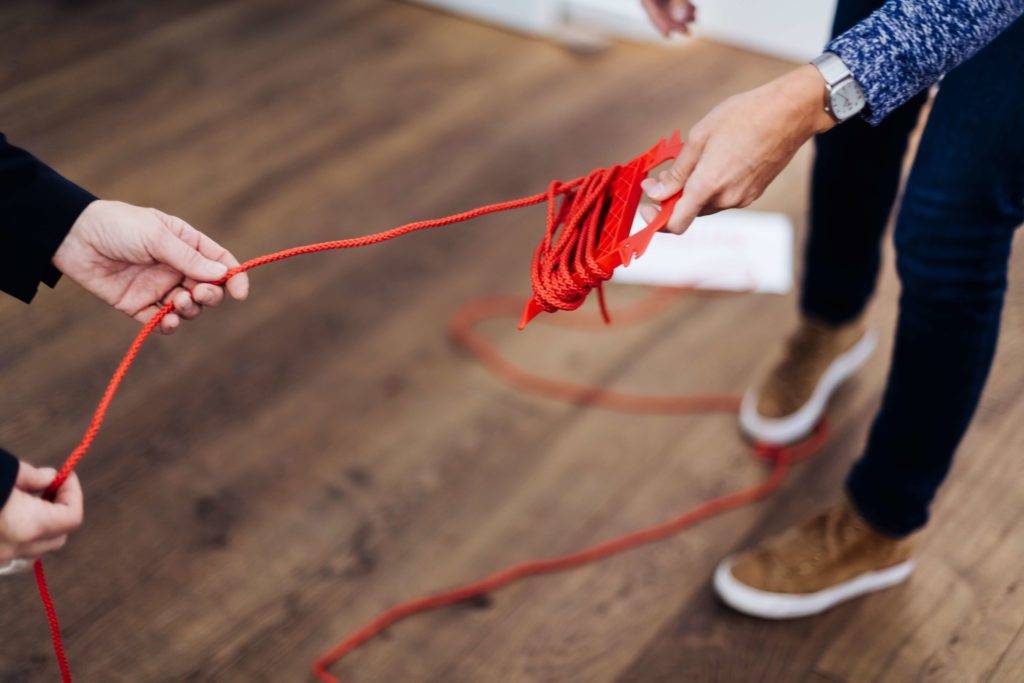 Coach & coachee with red thread to deal with the past