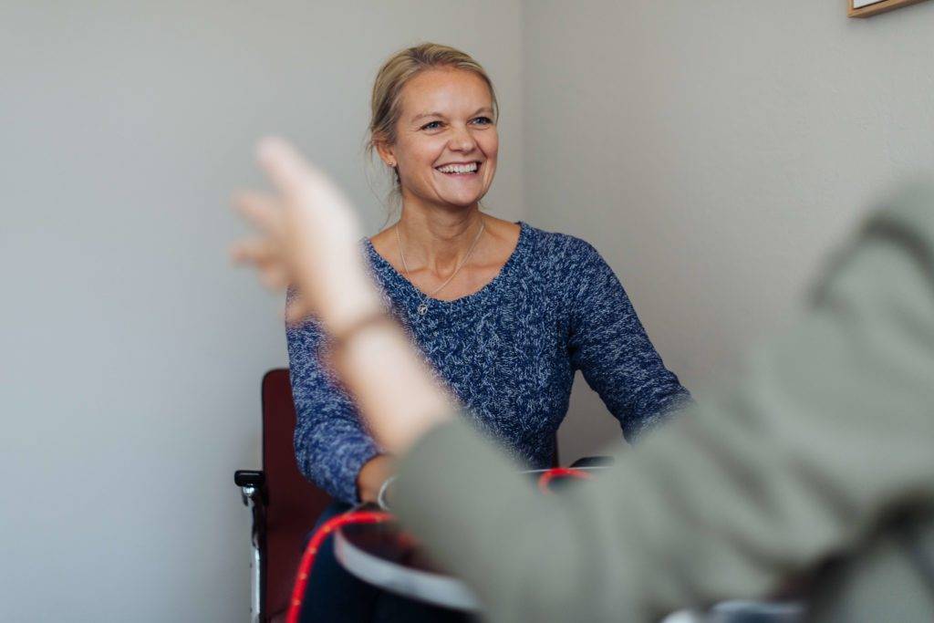 Coach laughs with client