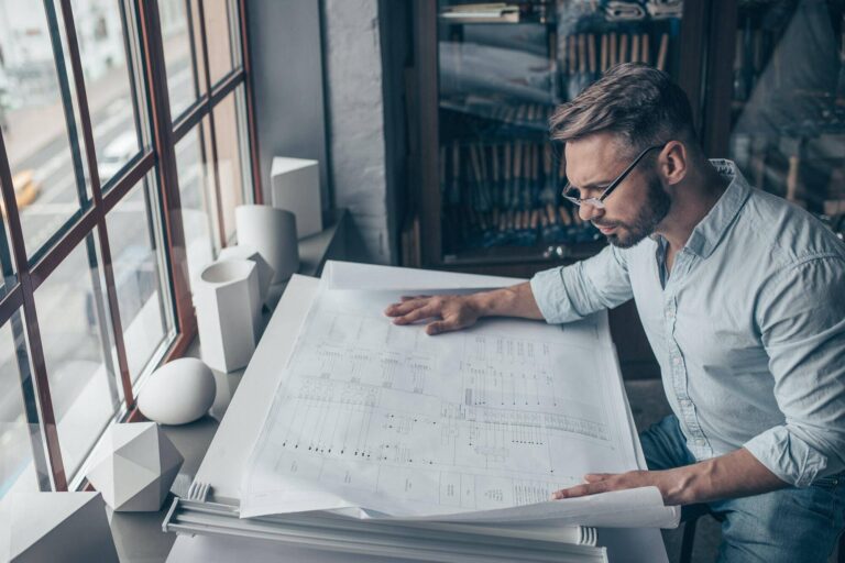 mature architect with a plan