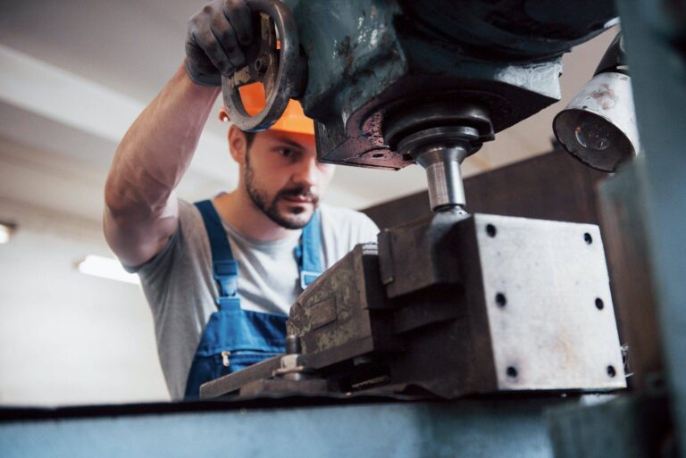 portrait of a young worker in a hard hat at a large waste recycling factory the engineer monitors
