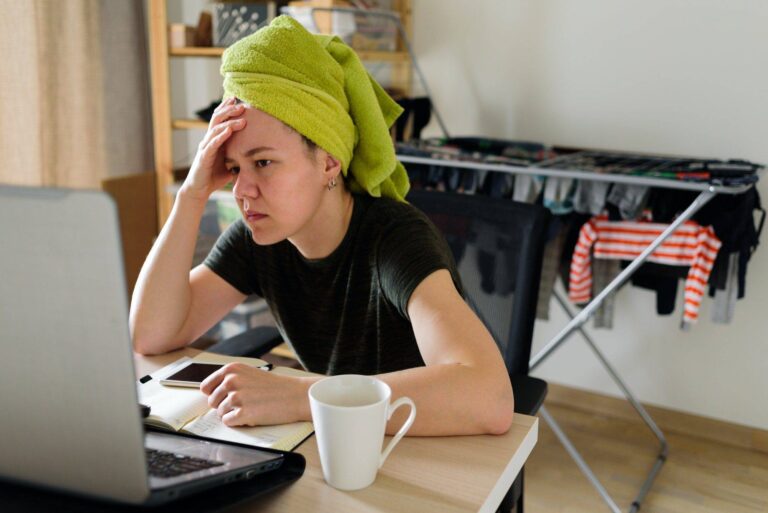 woman working from home thinking tired